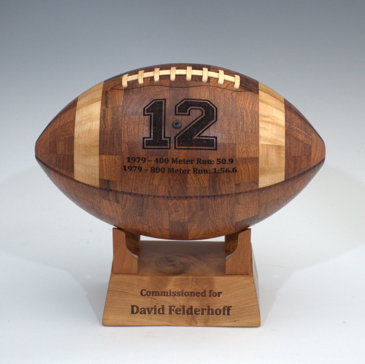 Wooden football-shaped trophy with engraved