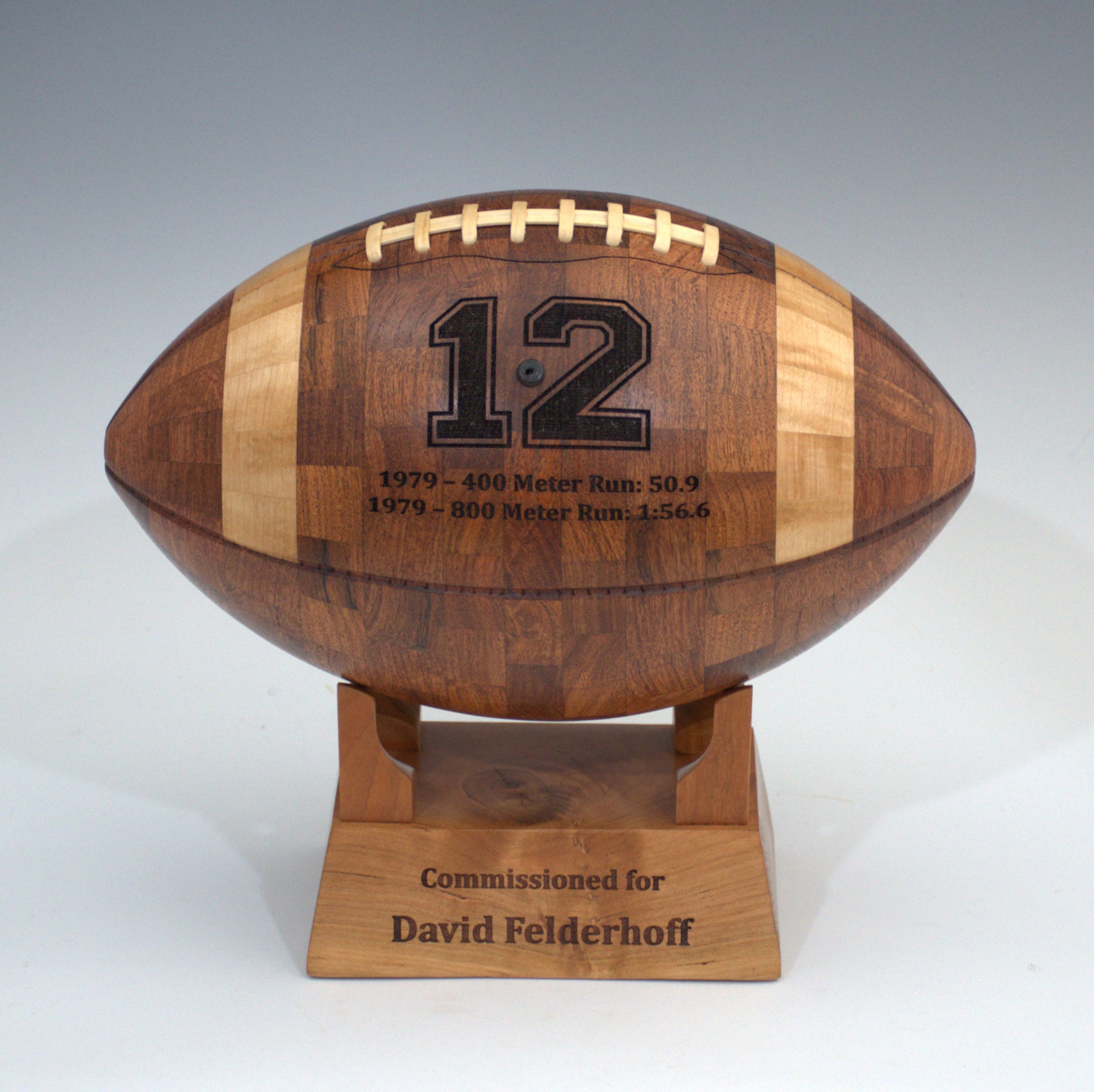 Wooden football-shaped trophy with engraved