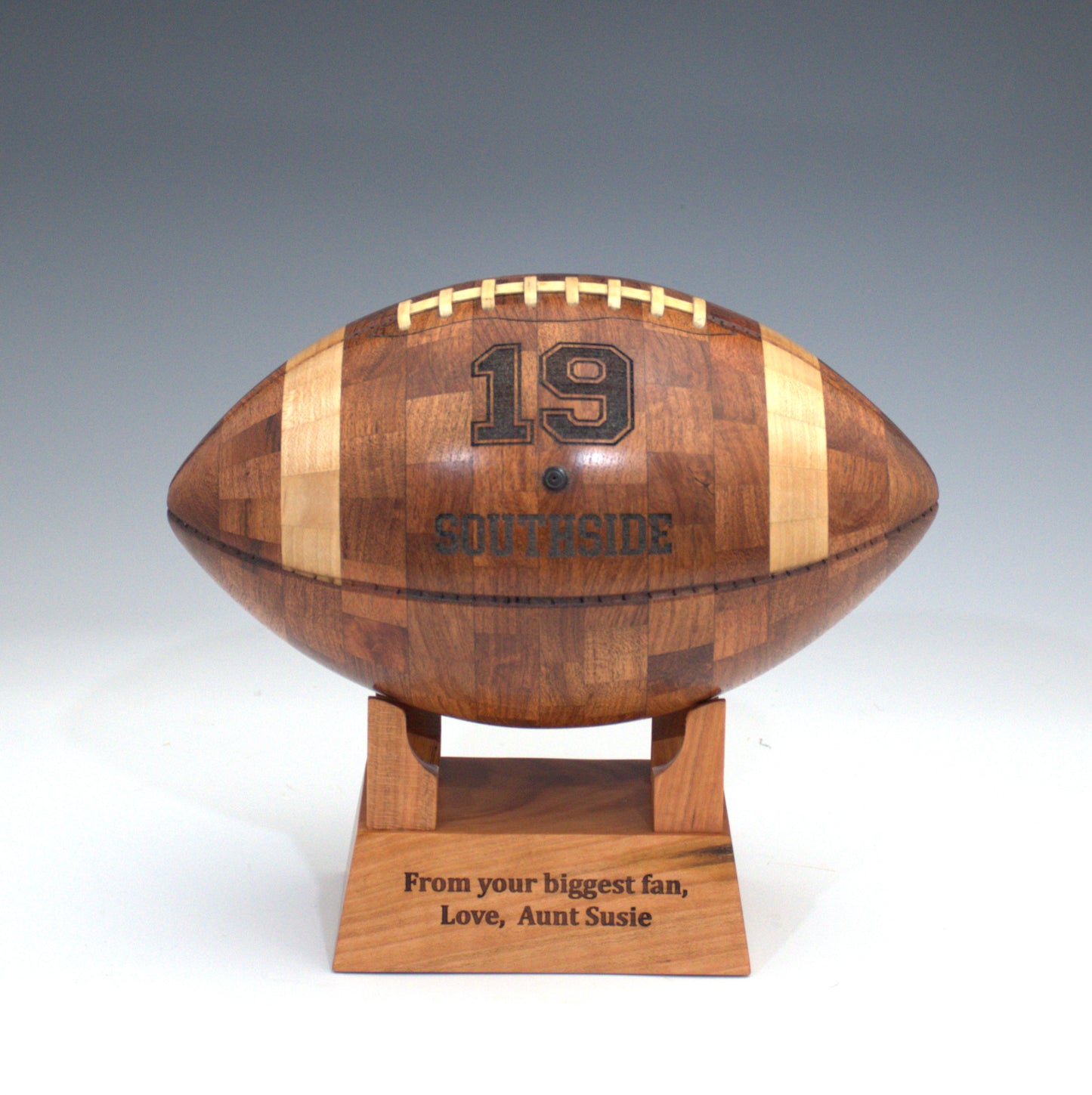 Wooden football-shaped trophy with engrave