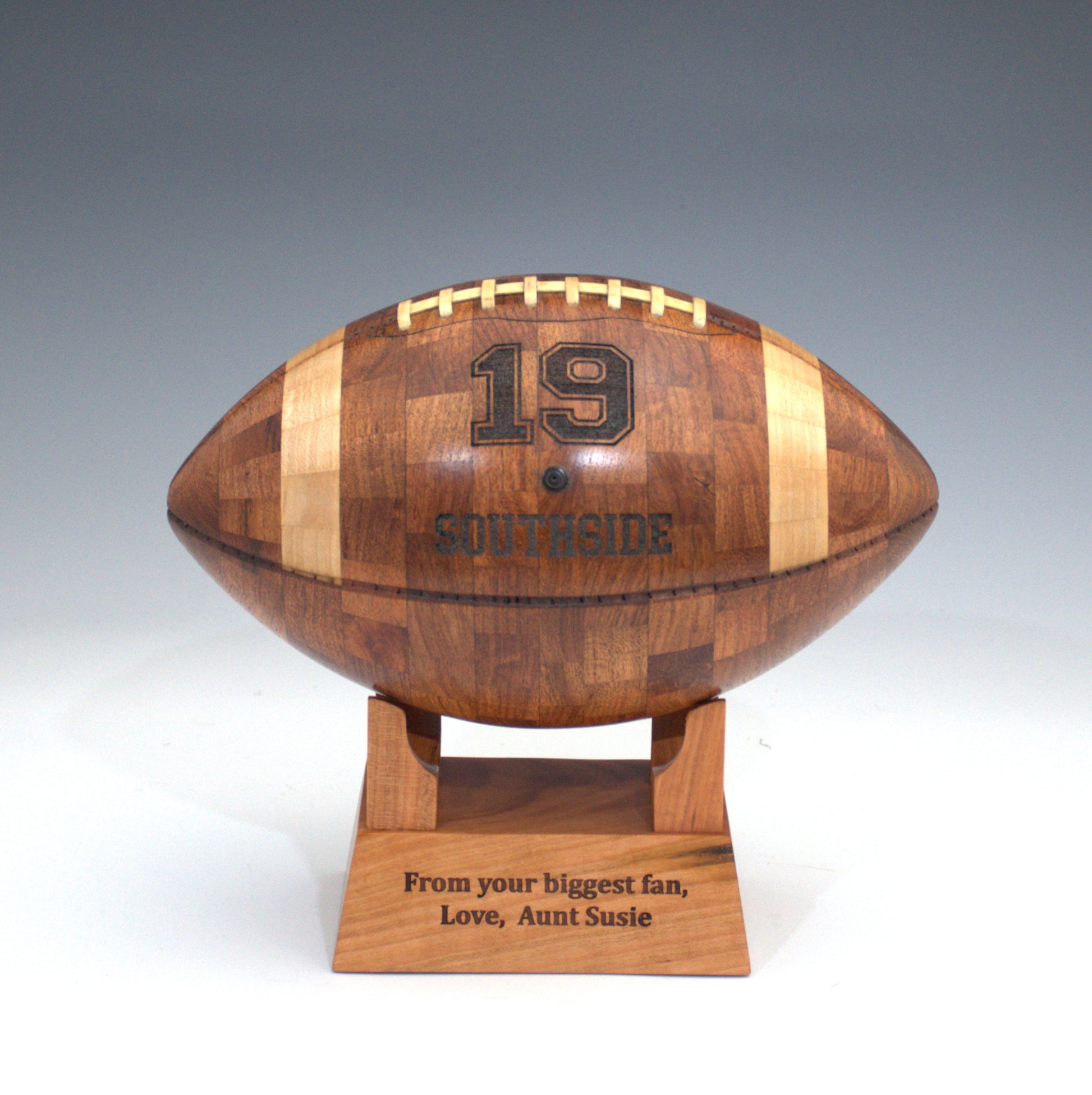 Wooden football-shaped trophy with engrave